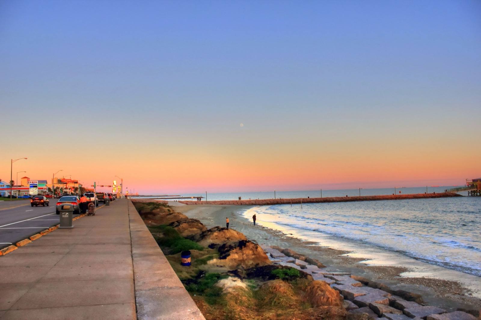 The Seawall walkway above the beach and the Gulf at dusk
