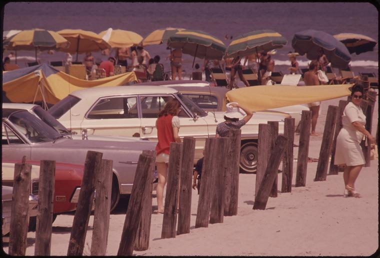Cars and umbrellas on Stewart Beach, 1973