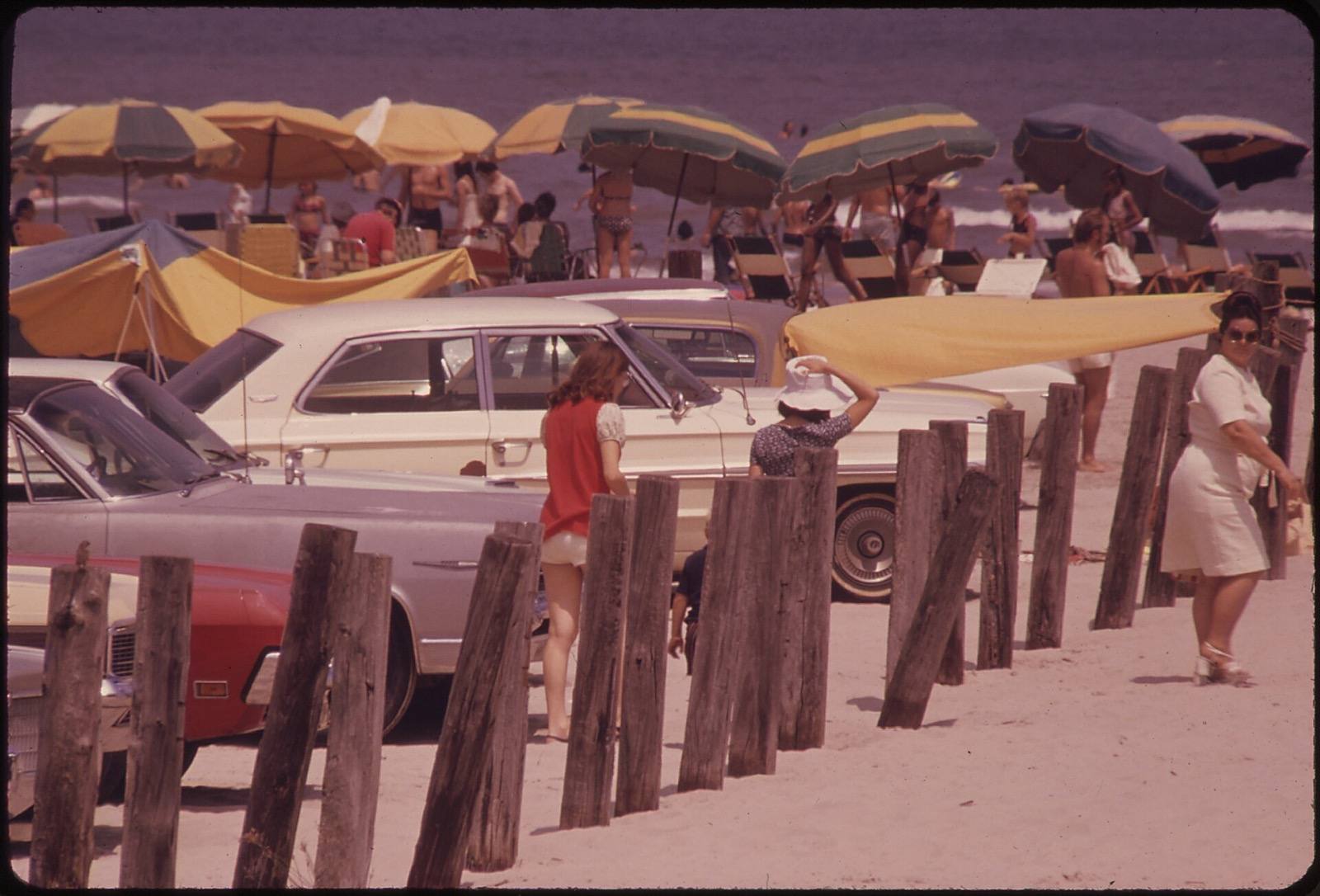 Cars and umbrellas on Stewart Beach in July 1973